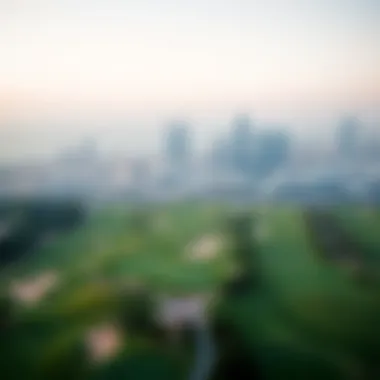 Aerial view of the lush green fairways at Dubai Golf Club with the skyline in the background