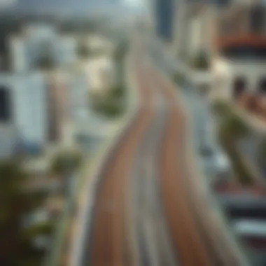 An aerial shot of the Dubai Metro tracks winding through the cityscape
